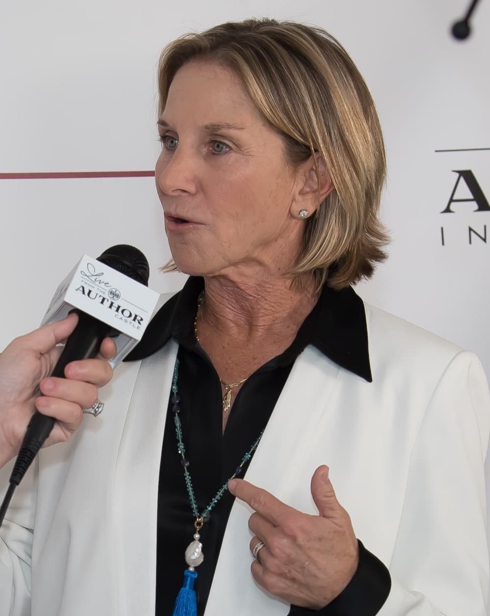 Dr. Susan Schiff speaking into a handheld microphone