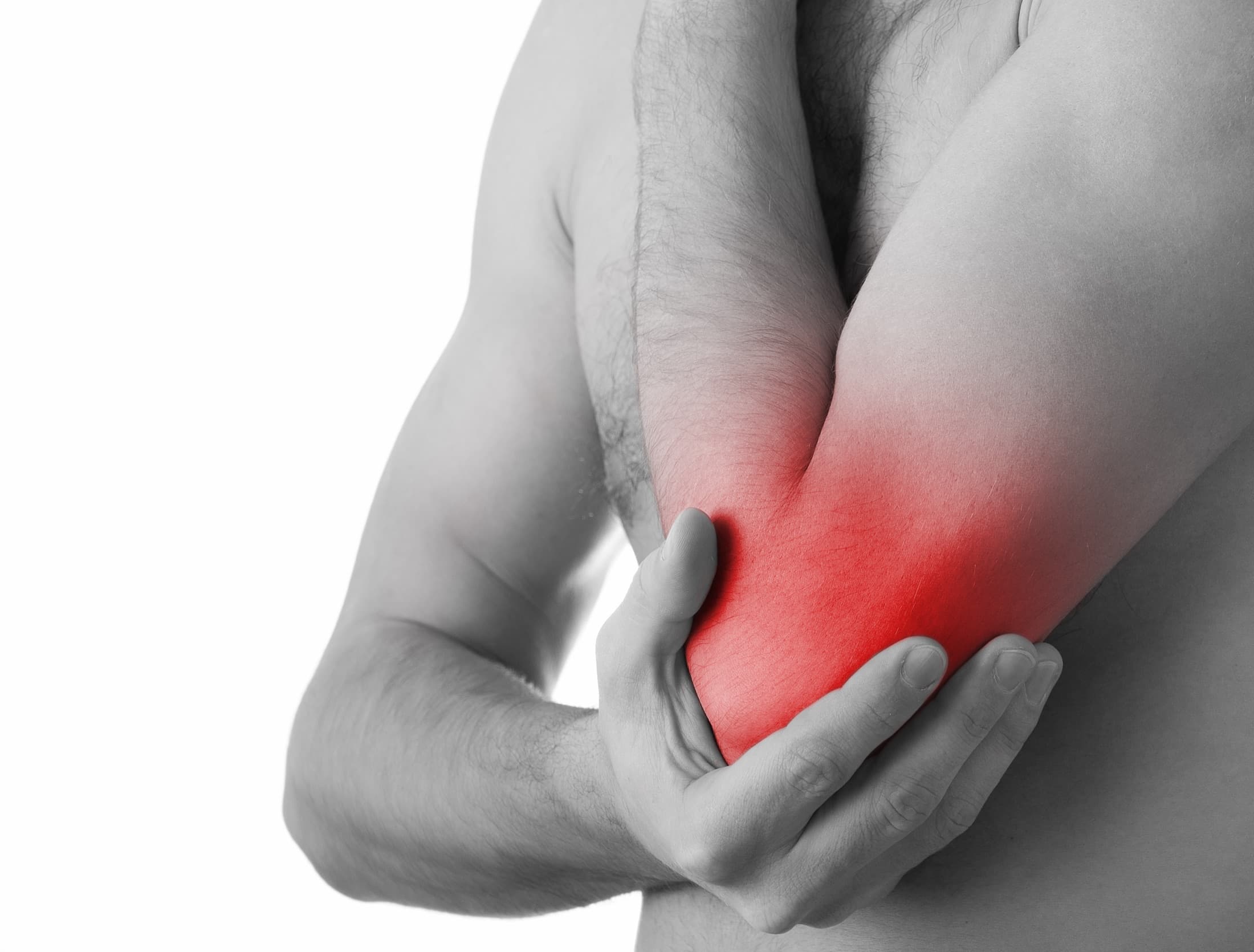 A man gripping his elbow, the elbow tinted red